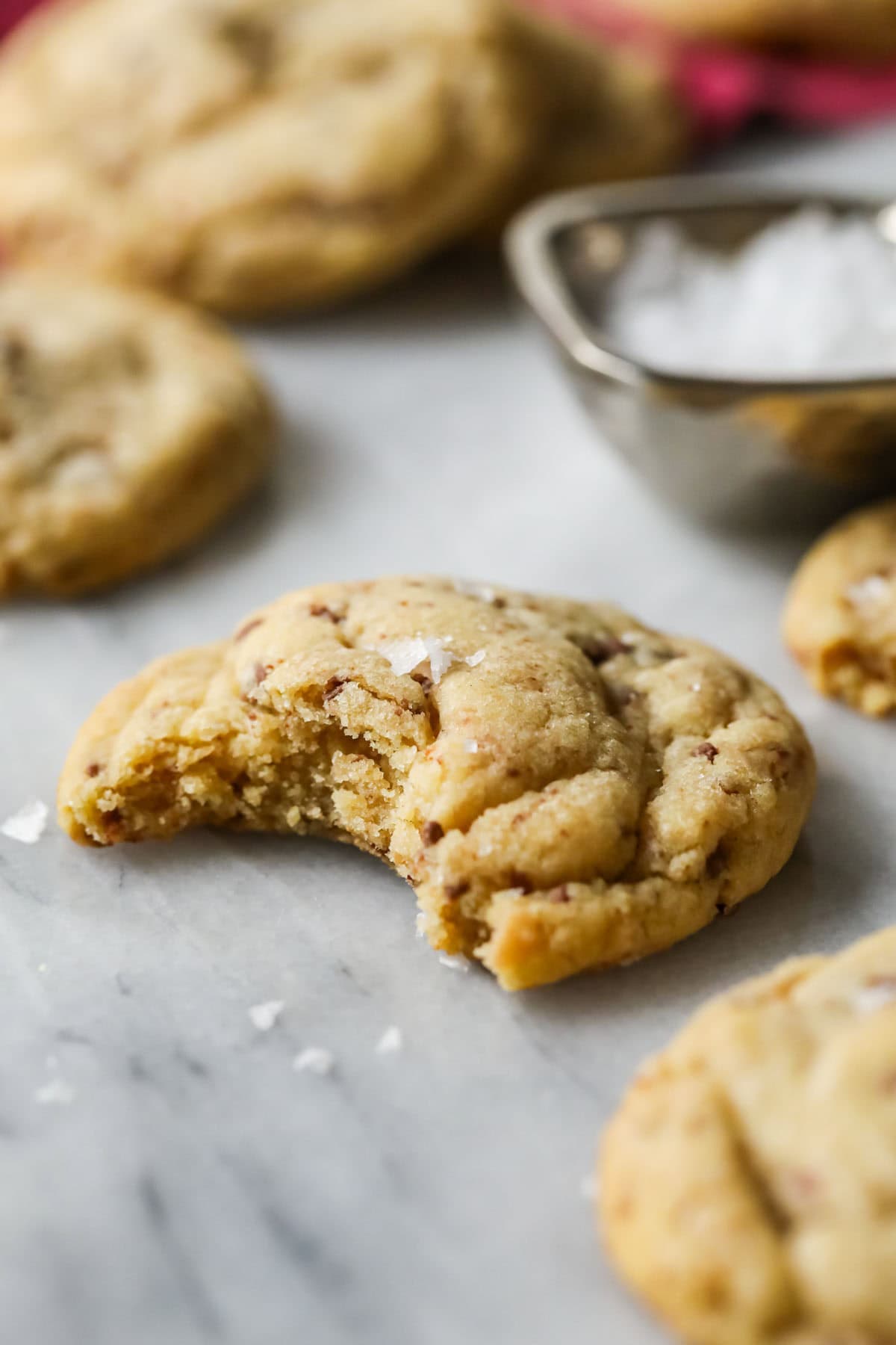 Cookie made with brown butter and toffee missing a bite.