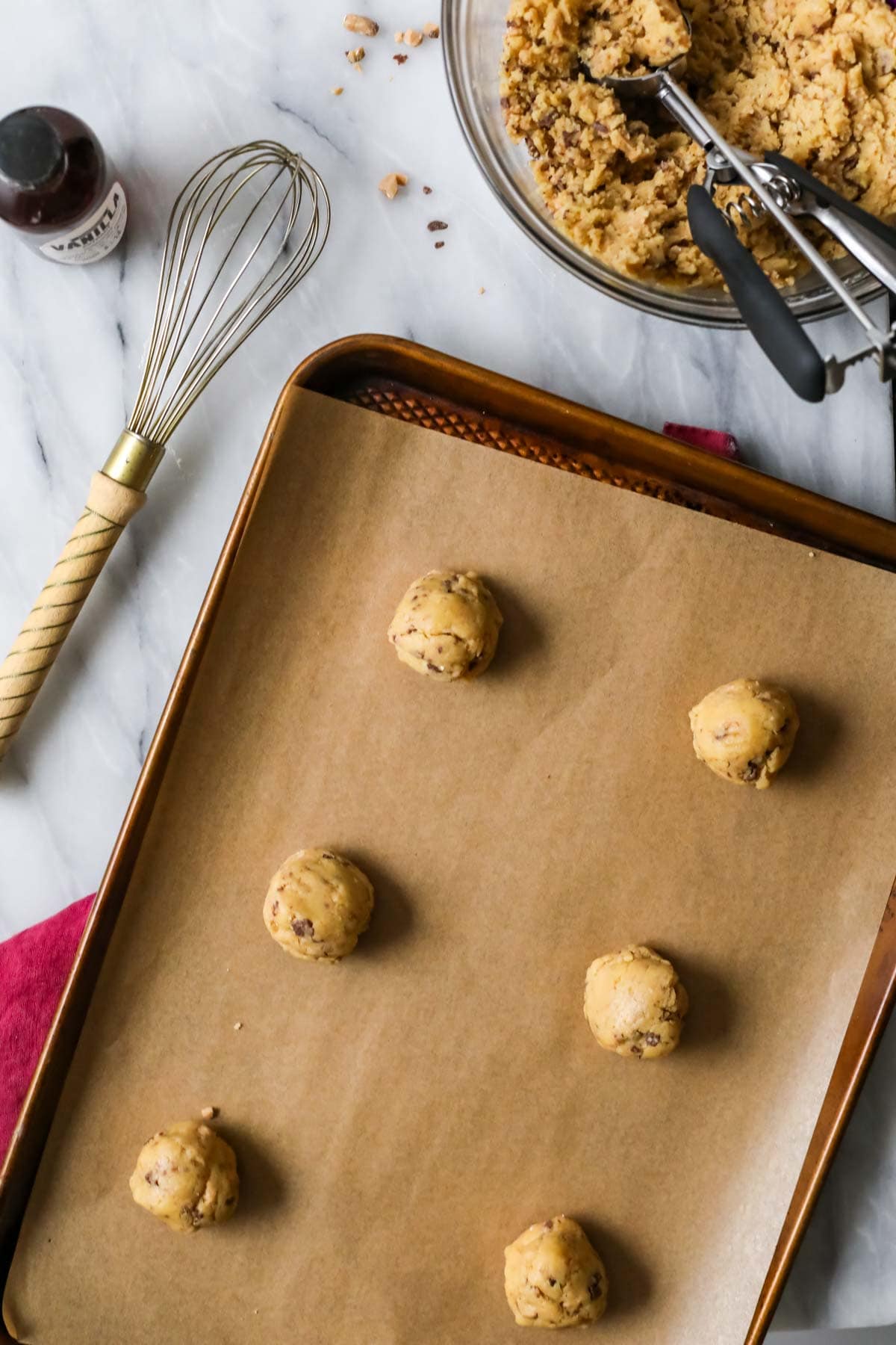 Overhead view of cookie dough balls on a baking sheet.