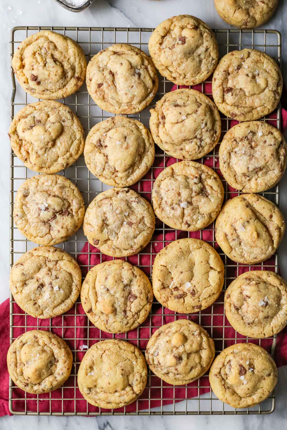 Overhead view of brown butter toffee cookies on a cooling rack.