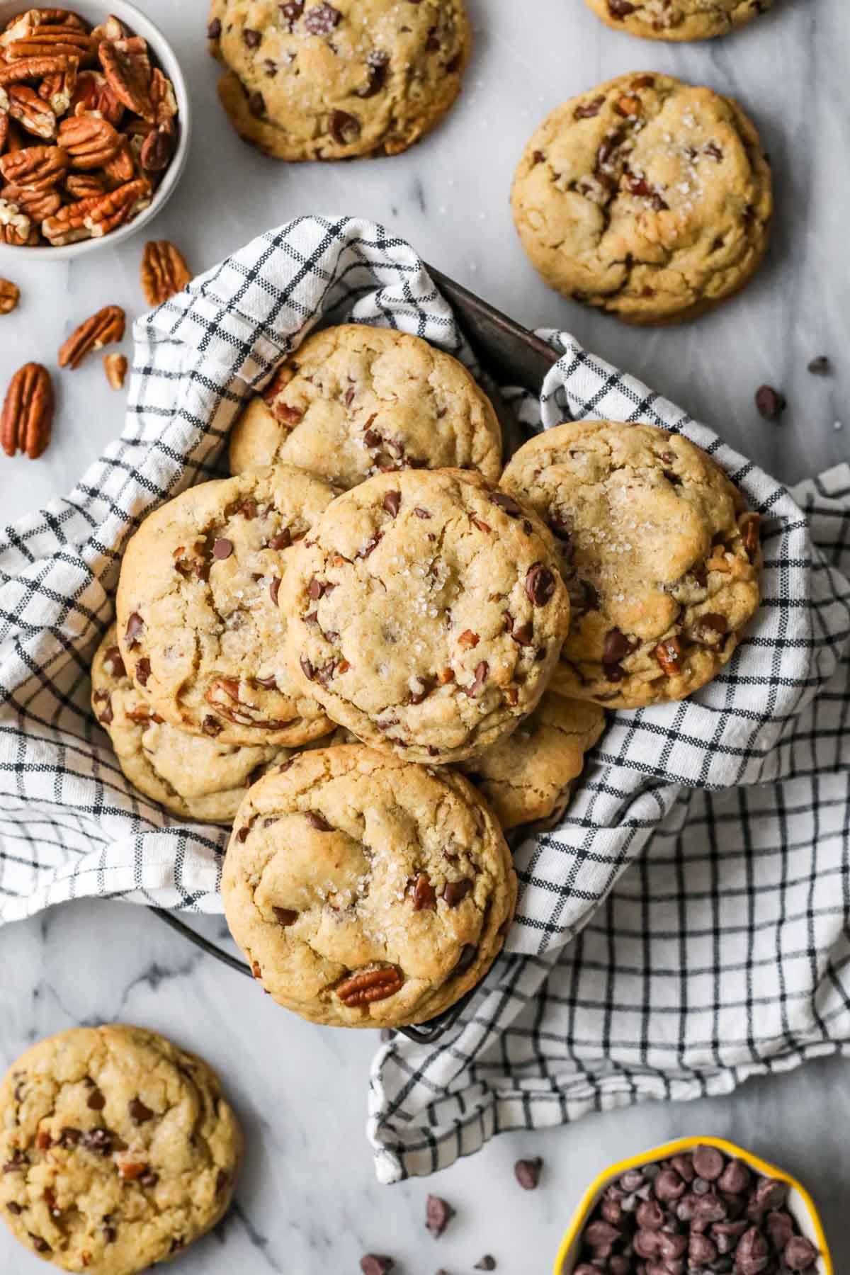 Overhead view of chocolate chip banana bread cookies in a tea towel lined dish.