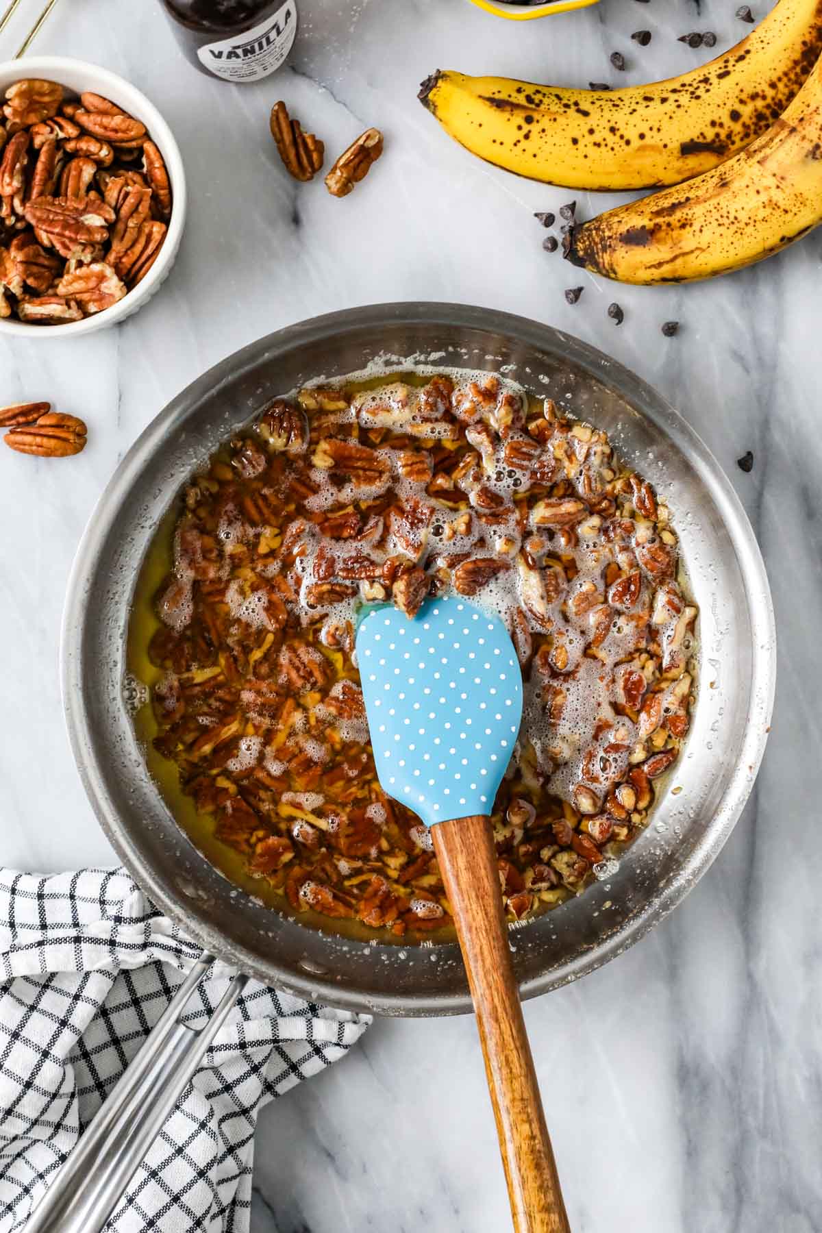 Overhead view of pecans toasting in brown butter.