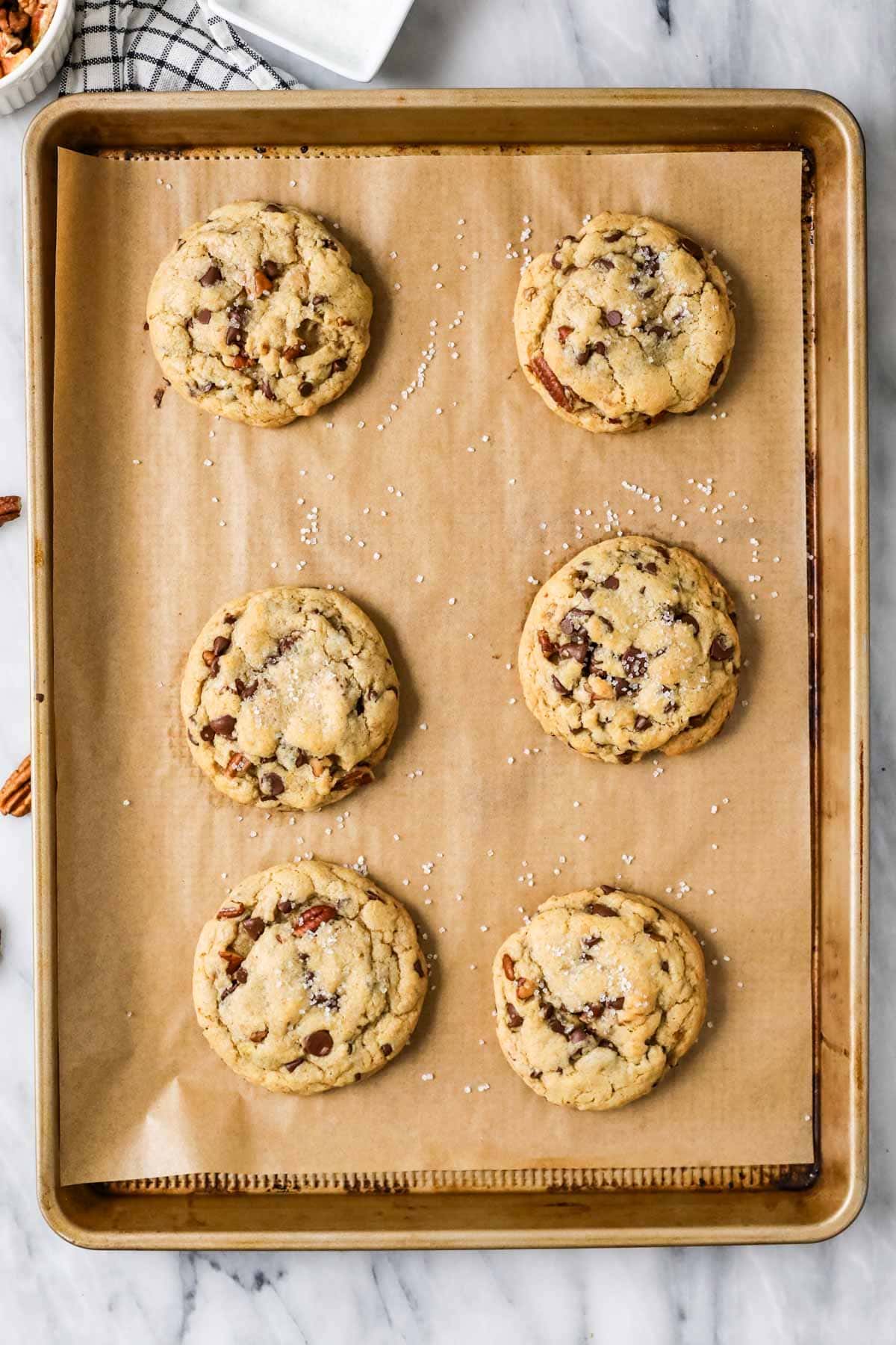 Overhead view of a baking sheet of banana bread cookies after baking.