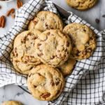 Overhead view of chocolate chip banana bread cookies in a tea towel lined dish.