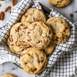 Overhead view of chocolate chip banana bread cookies in a tea towel lined dish.