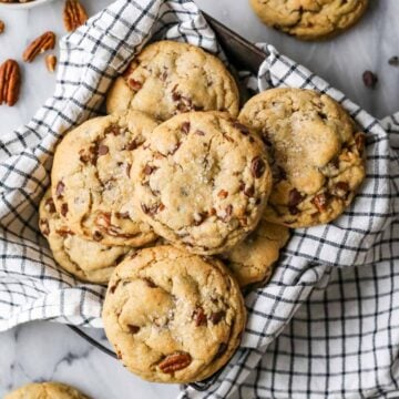 Overhead view of chocolate chip banana bread cookies in a tea towel lined dish.