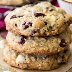 Stack of three white chocolate cranberry oatmeal cookies.