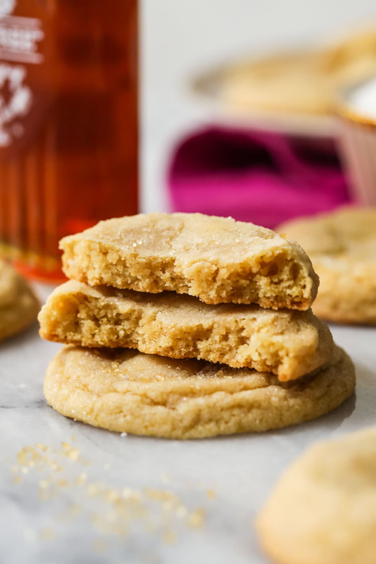 Stack of maple brown sugar cookies with the top cookies missing bites.