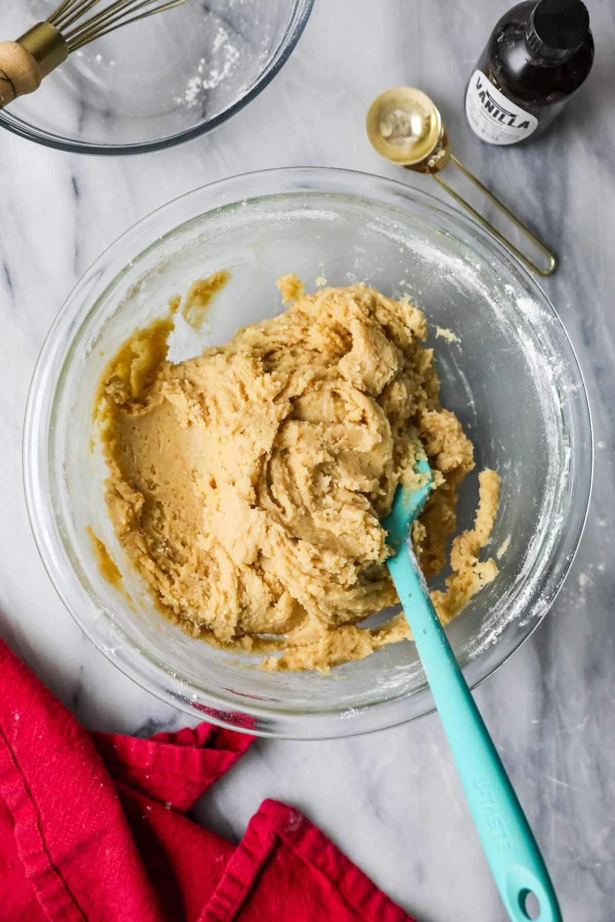 Overhead view of a bowl of cookie dough made with brown sugar and maple syrup.