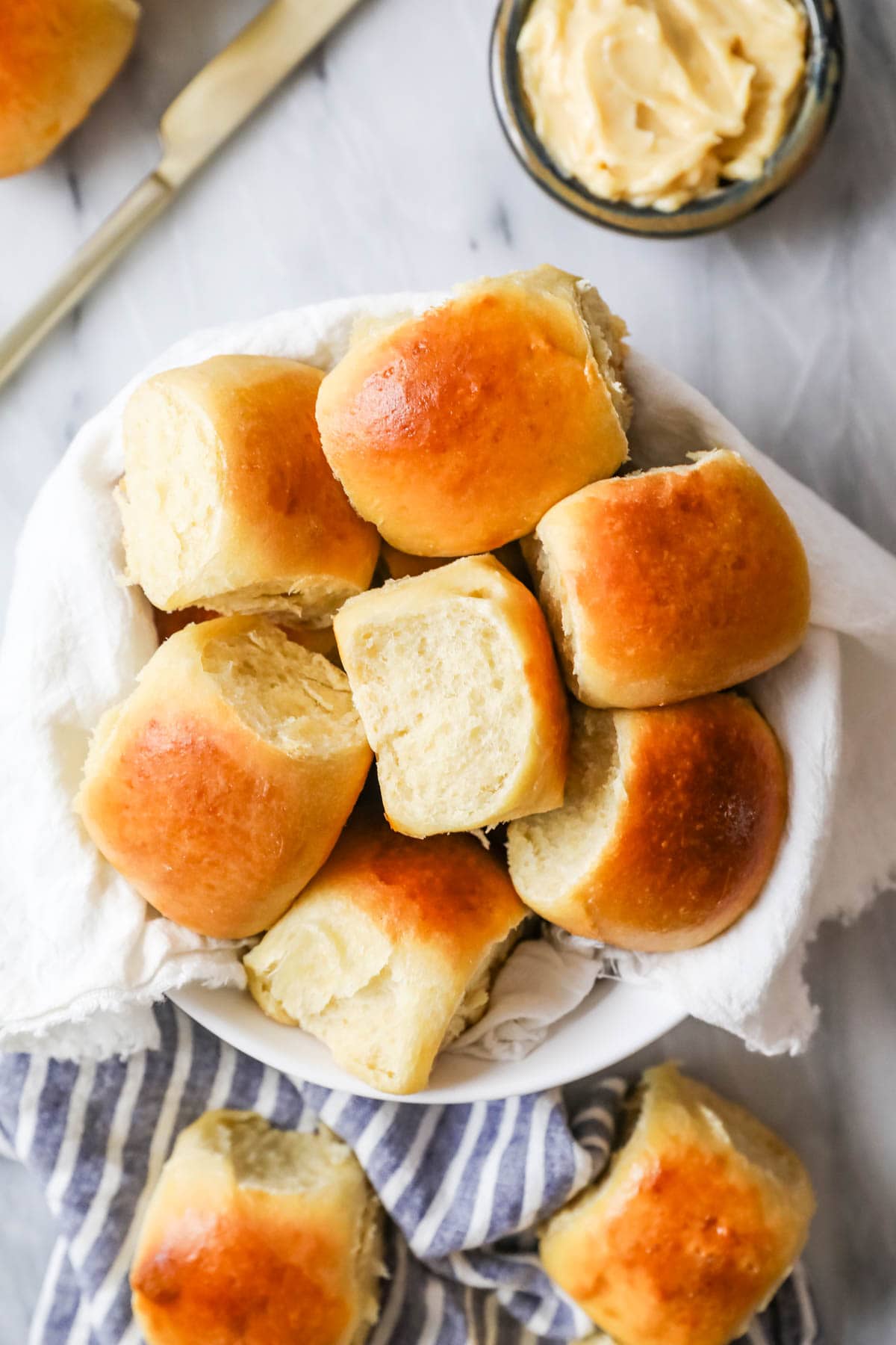 Overhead view of a serving bowl of dinner rolls made with sourdough starter.