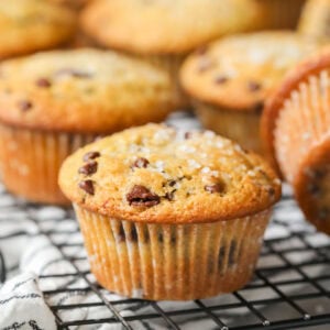 Close-up view of a sourdough chocolate chip muffin on a cooling rack.