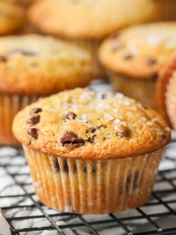 Close-up view of a sourdough chocolate chip muffin on a cooling rack.