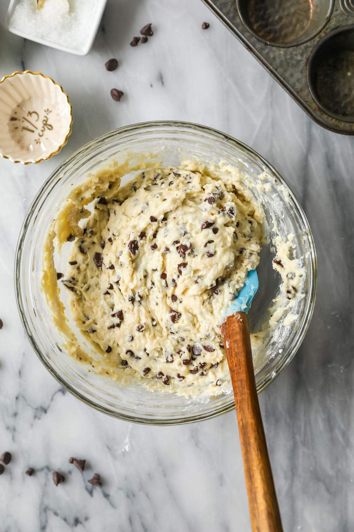 Overhead view of a bowl of muffin batter after folding in chocolate chips .