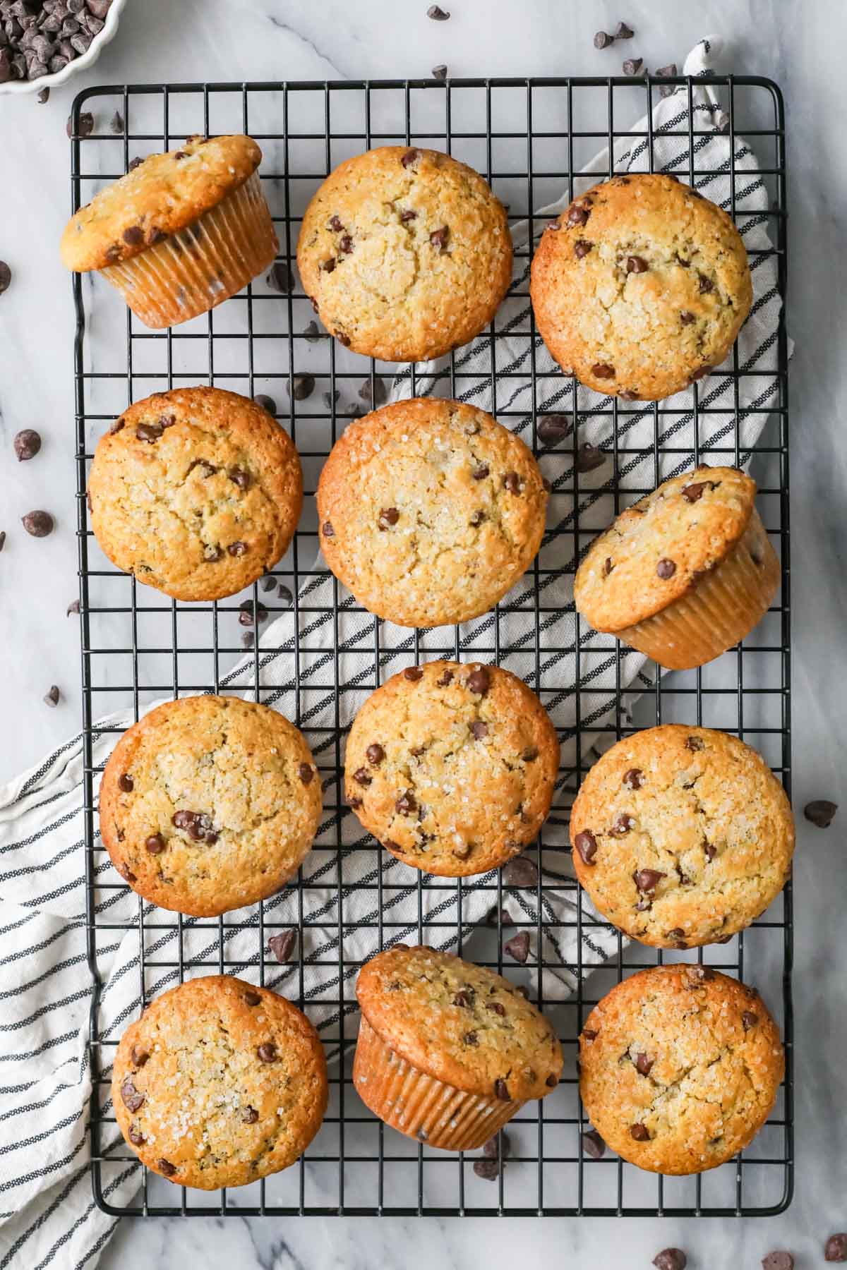 Overhead view of sourdough chocolate chip muffins on a cooling rack.