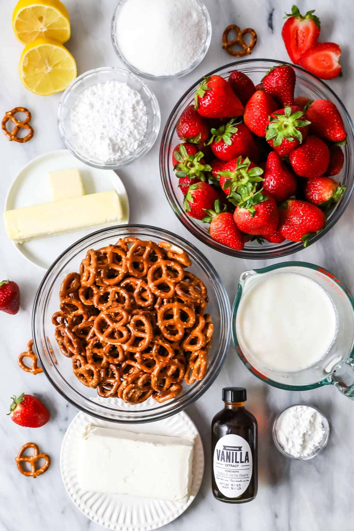 Overhead view of ingredients including strawberries, pretzels, cream cheese, and more.