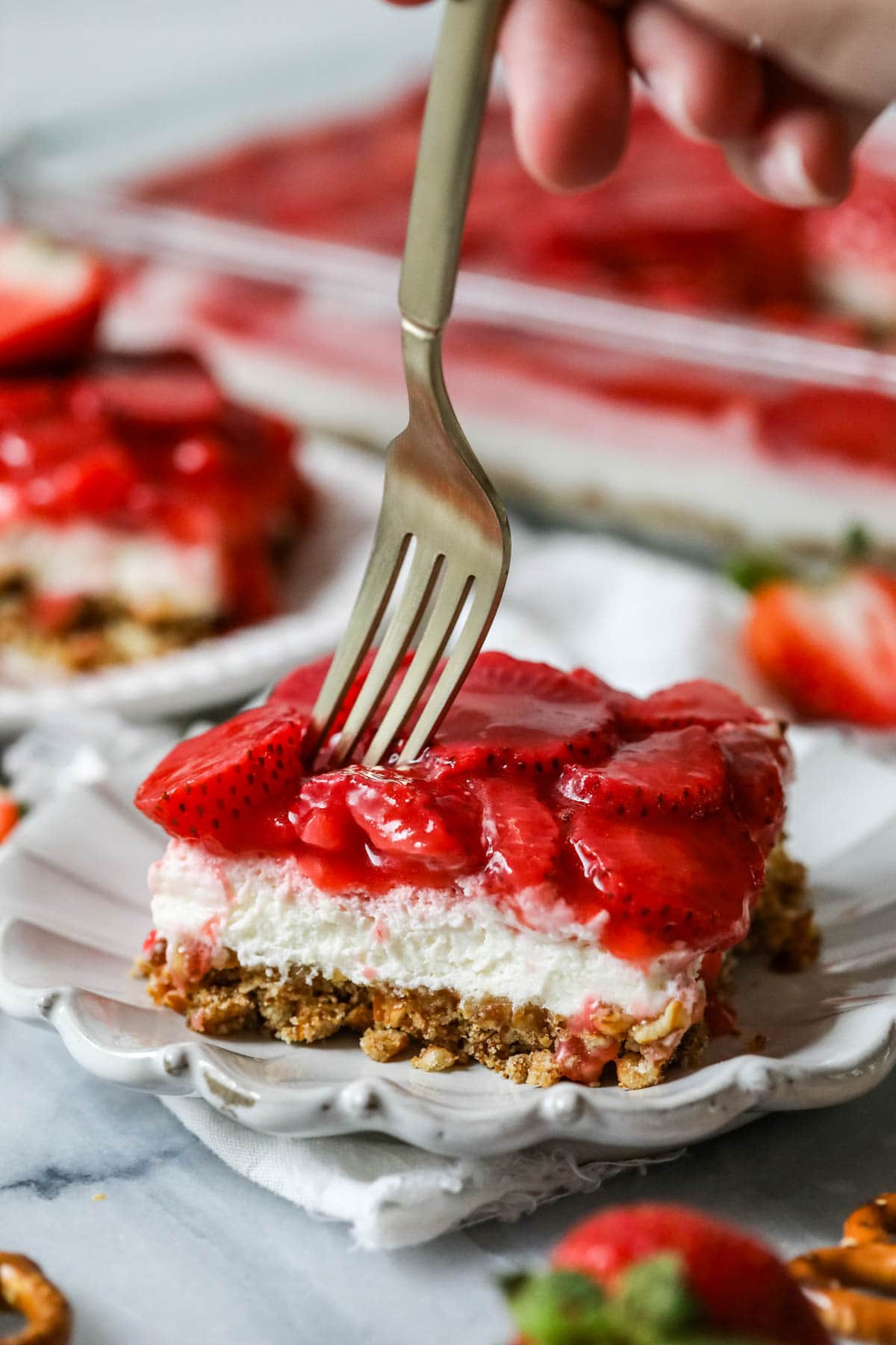 For taking a bite from a layered strawberry, pretzel, and cream cheese dessert.