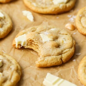 Close-up view of a white chocolate macadamia nut cookie missing a bite.