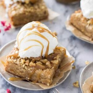 Blondie on a plate with a scoop of ice cream on top.