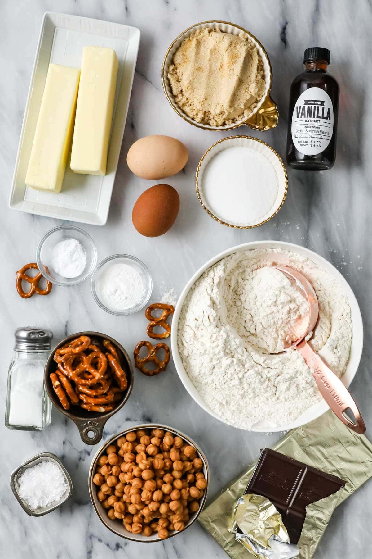 Overhead view of ingredients including pretzels, caramel bits, chocolate, and more.