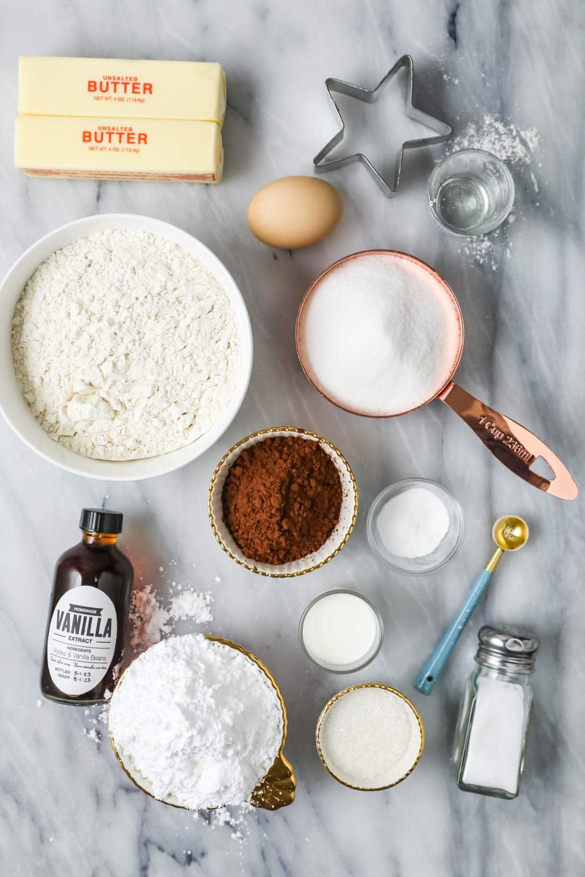 Overhead view of ingredients including flour, cocoa powder, powdered sugar, and more.