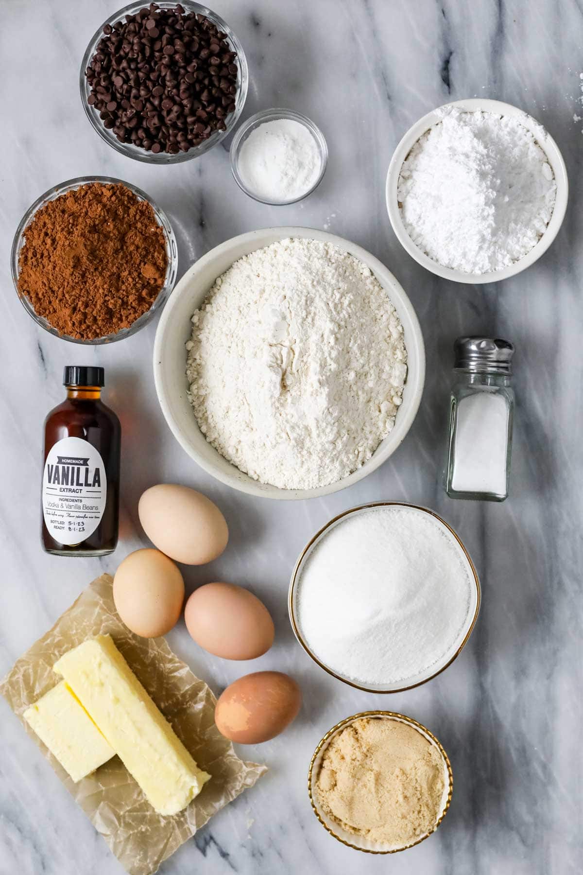 Overhead view of ingredients including cocoa powder, chocolate chips, powdered sugar, and more.