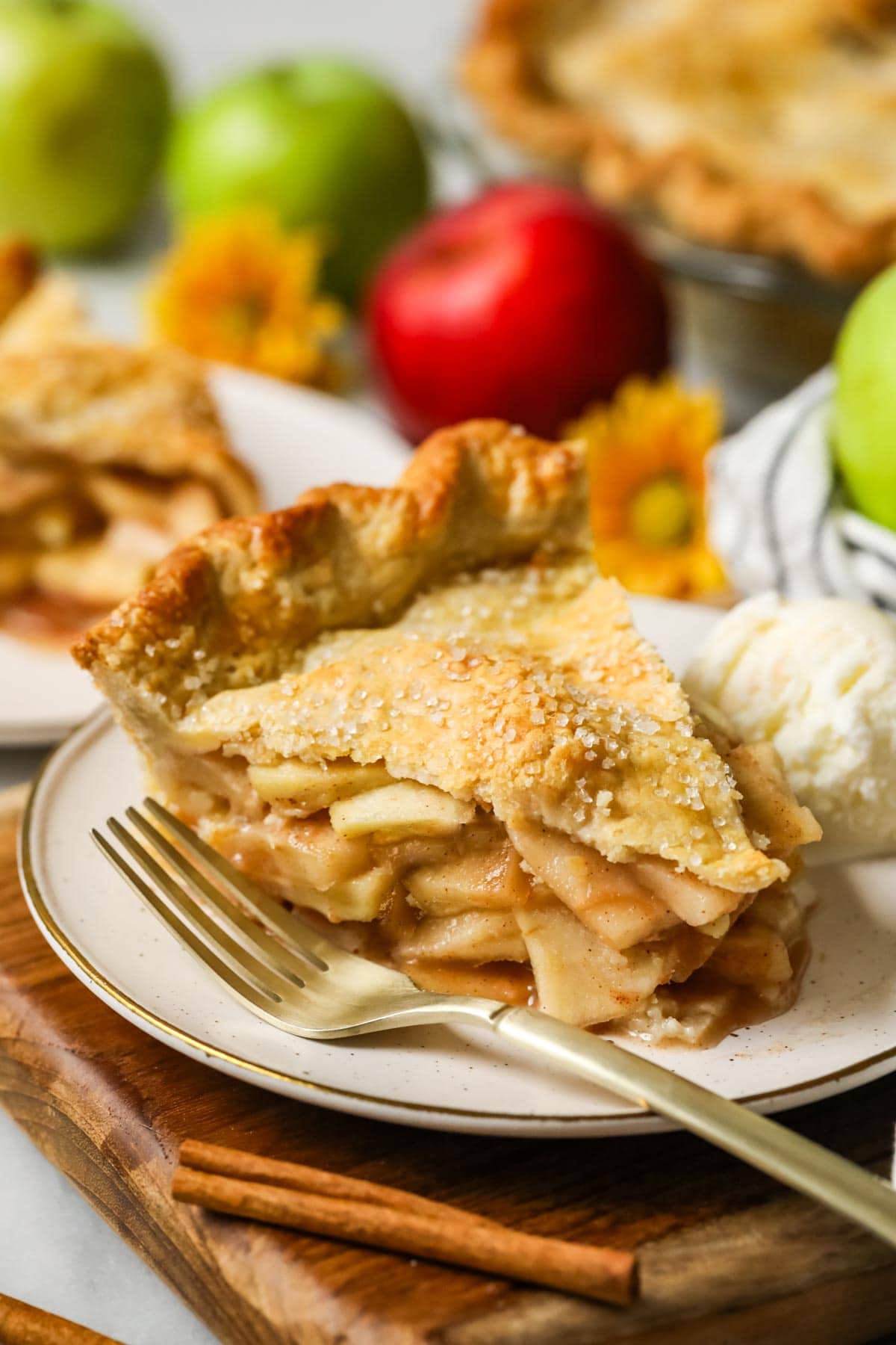 Slice of pie made from an easy apple pie recipe on a plate with a fork beside it.