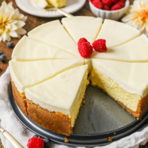 New York cheesecake that's been cut into slices with one slice missing.