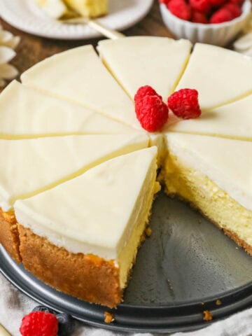 New York cheesecake that's been cut into slices with one slice missing.