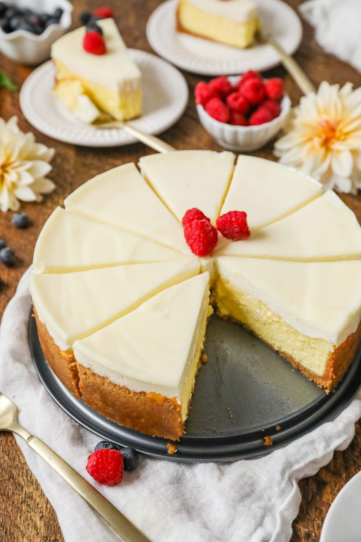 New York cheesecake that's been cut into slices with one slice missing.