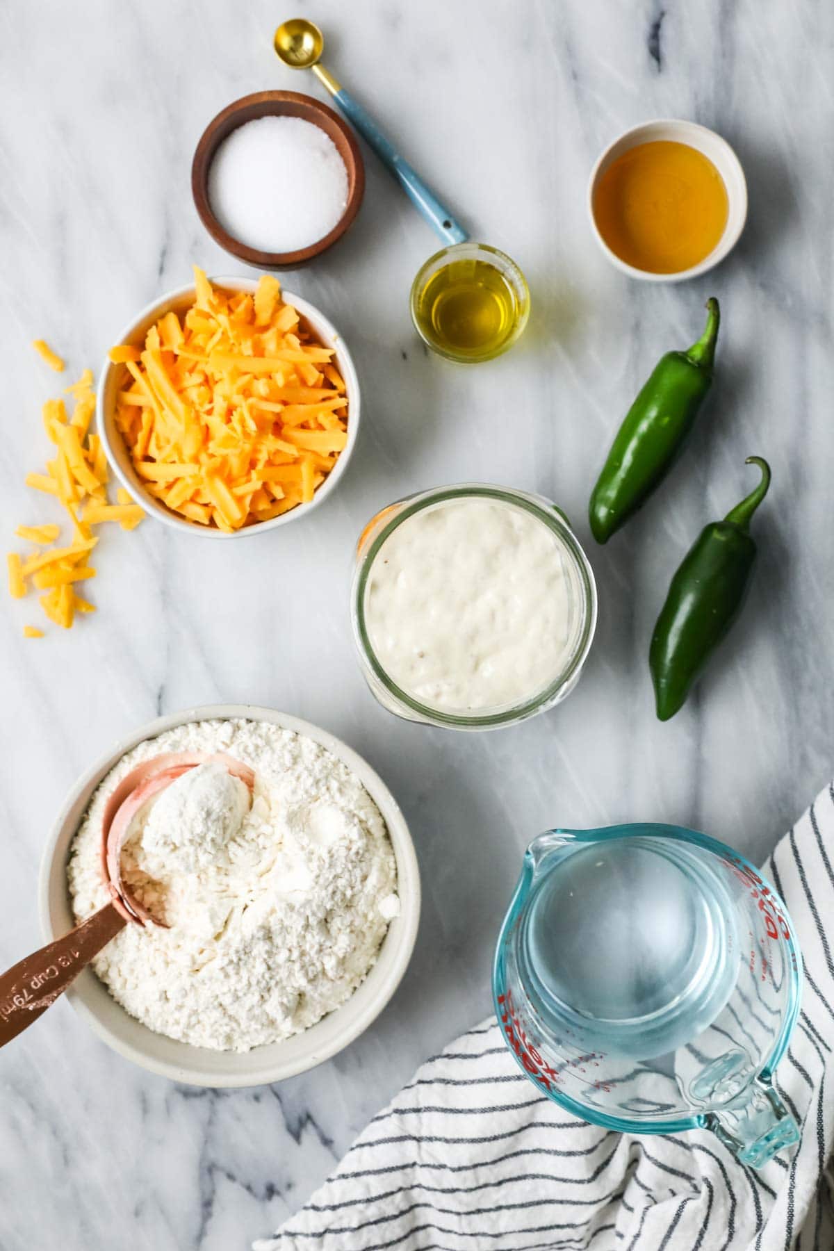 Overhead view of ingredients including sourdough starter, jalapeno, cheddar cheese, and more.