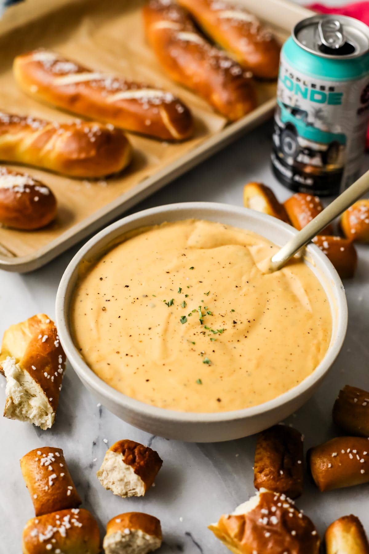 Beer cheese dip surrounded by soft pretzel pieces.