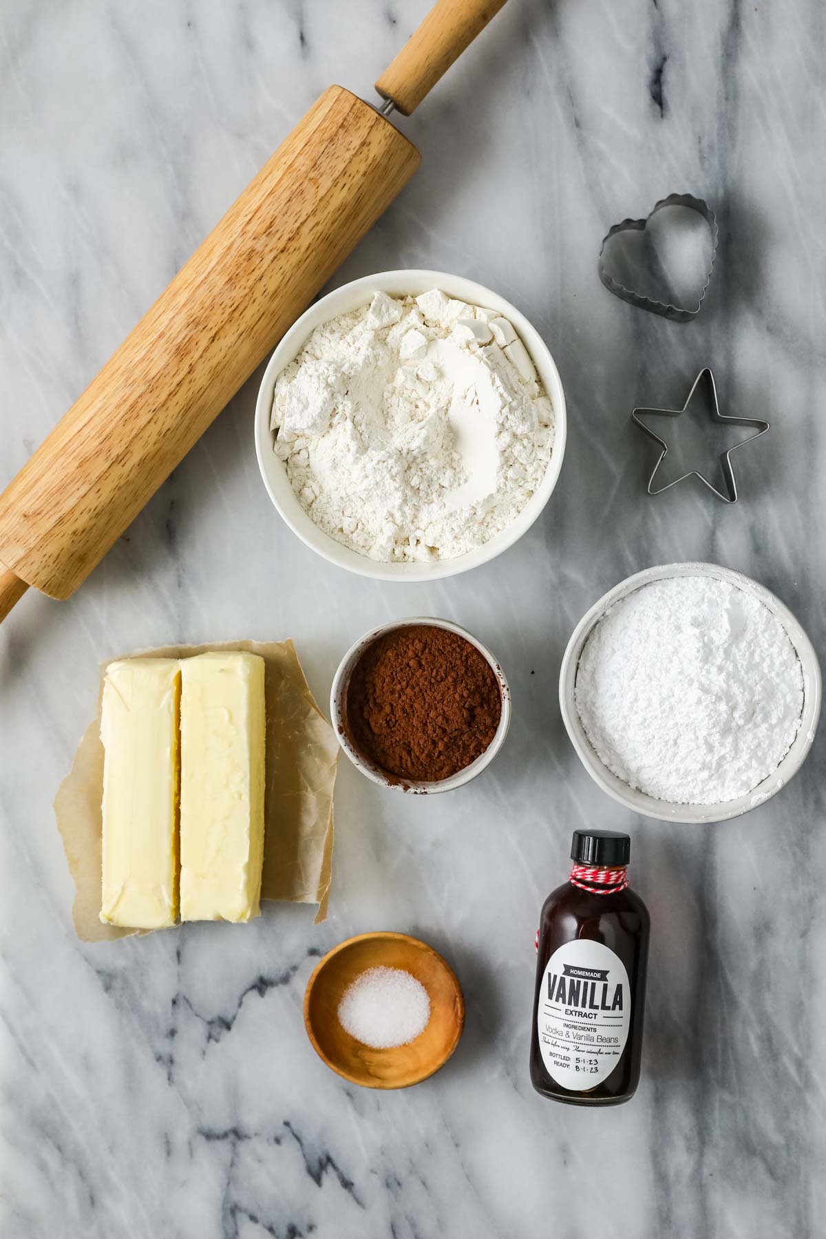 Overhead view of ingredients including butter, flour, cocoa powder, and more.