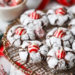 Christmas kiss cookies made with candy cane kisses on a cooling rack.