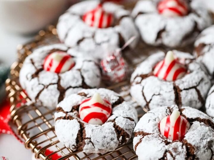 Christmas kiss cookies made with candy cane kisses on a cooling rack.