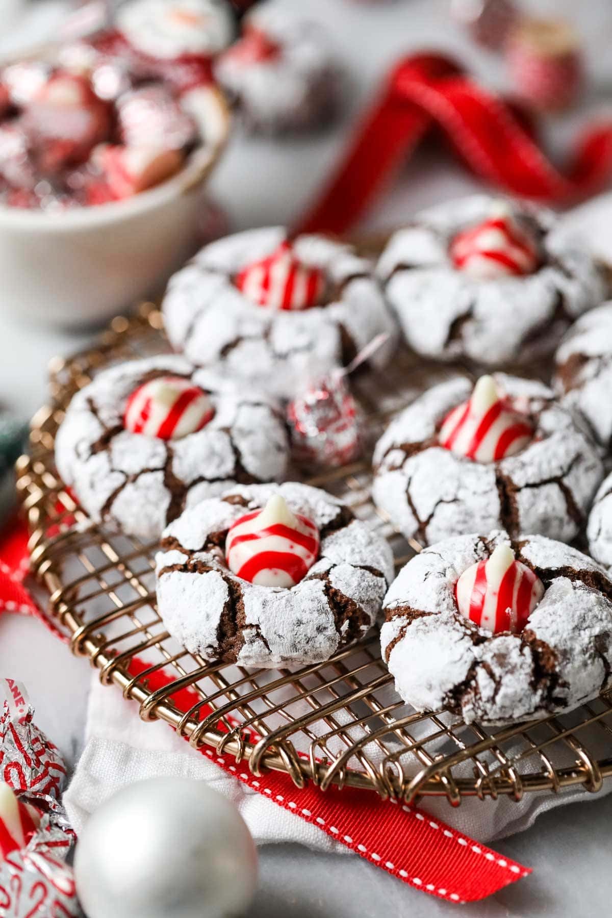 Christmas kiss cookies made with candy cane kisses on a cooling rack.