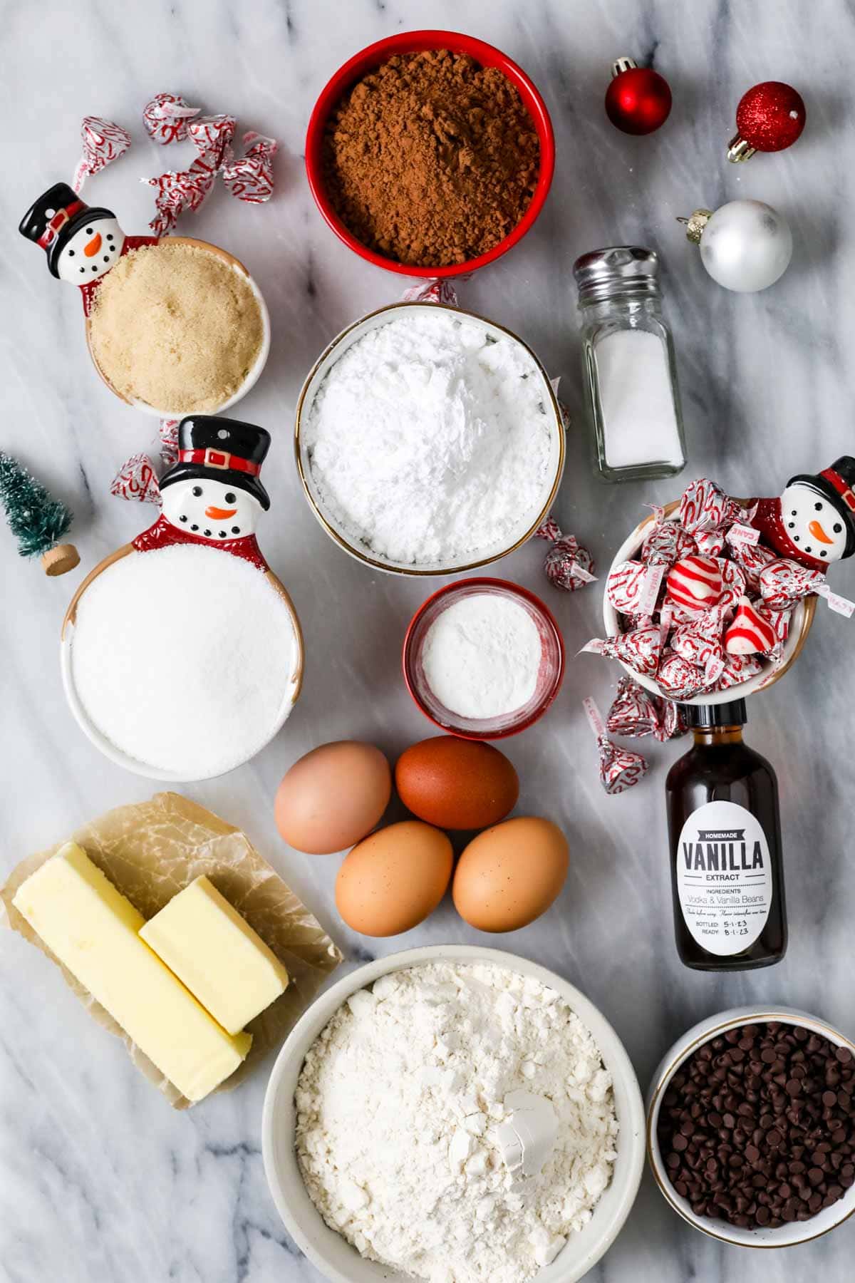 Overhead view of ingredients including cocoa powder, candy cane kisses, brown sugar, and more.