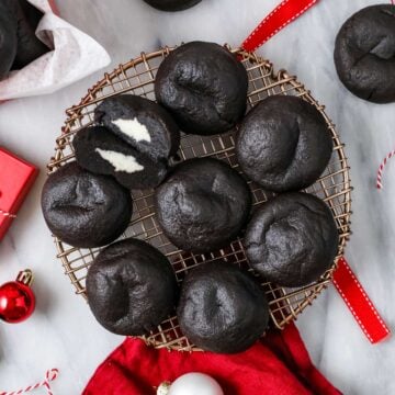 Overhead view of Christmas coal cookies on a round metal rack.