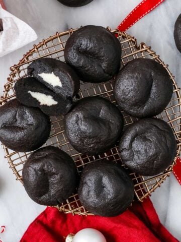 Overhead view of Christmas coal cookies on a round metal rack.