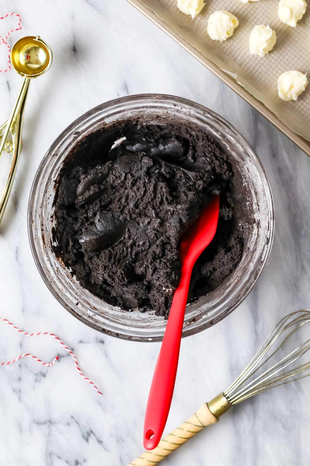 Overhead view of a bowl of cookie dough made with black cocoa.