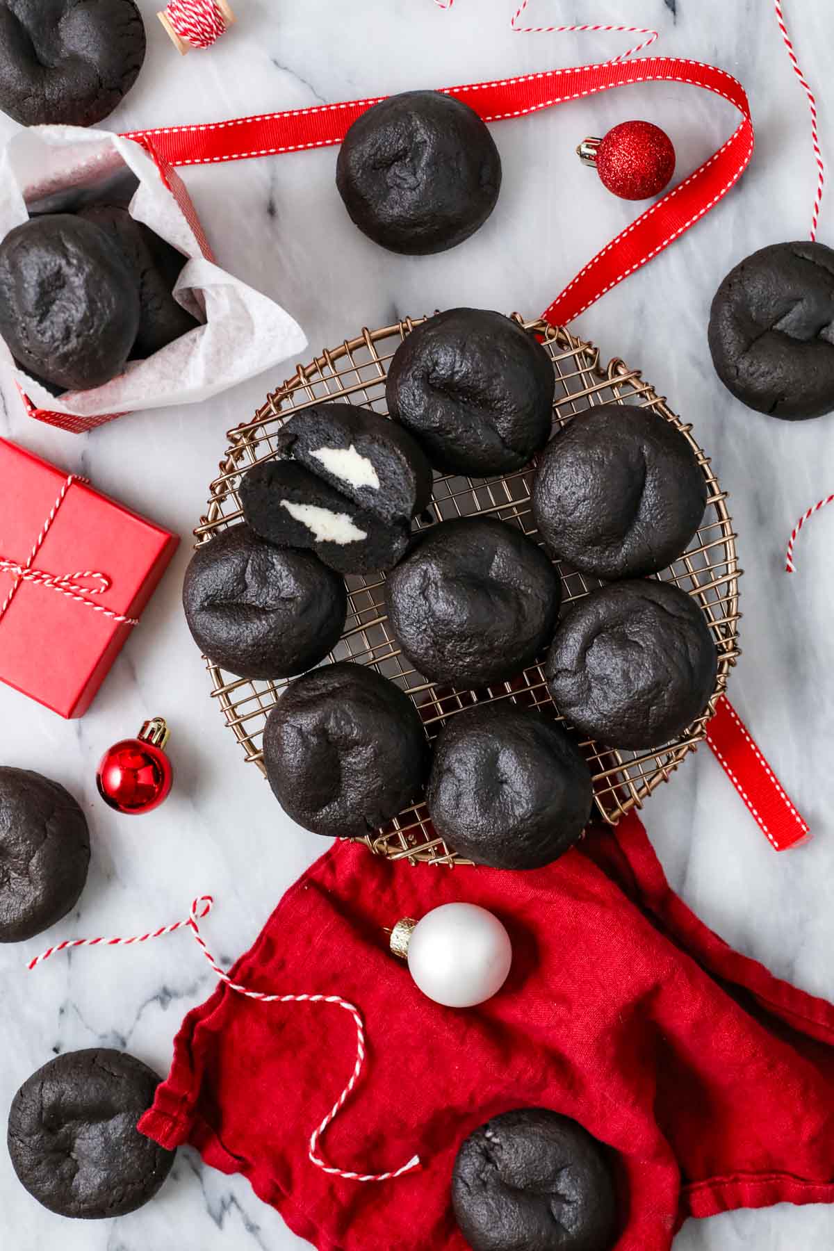 Overhead view of Christmas coal cookies on a round metal rack.