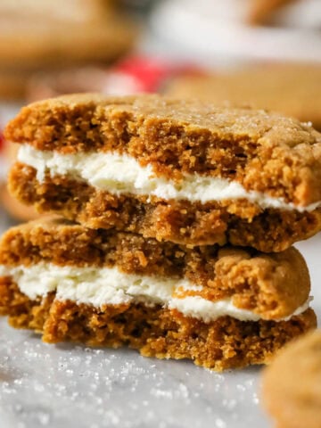 Two halves of a gingerbread sandwich cookie stacked on top of each other.