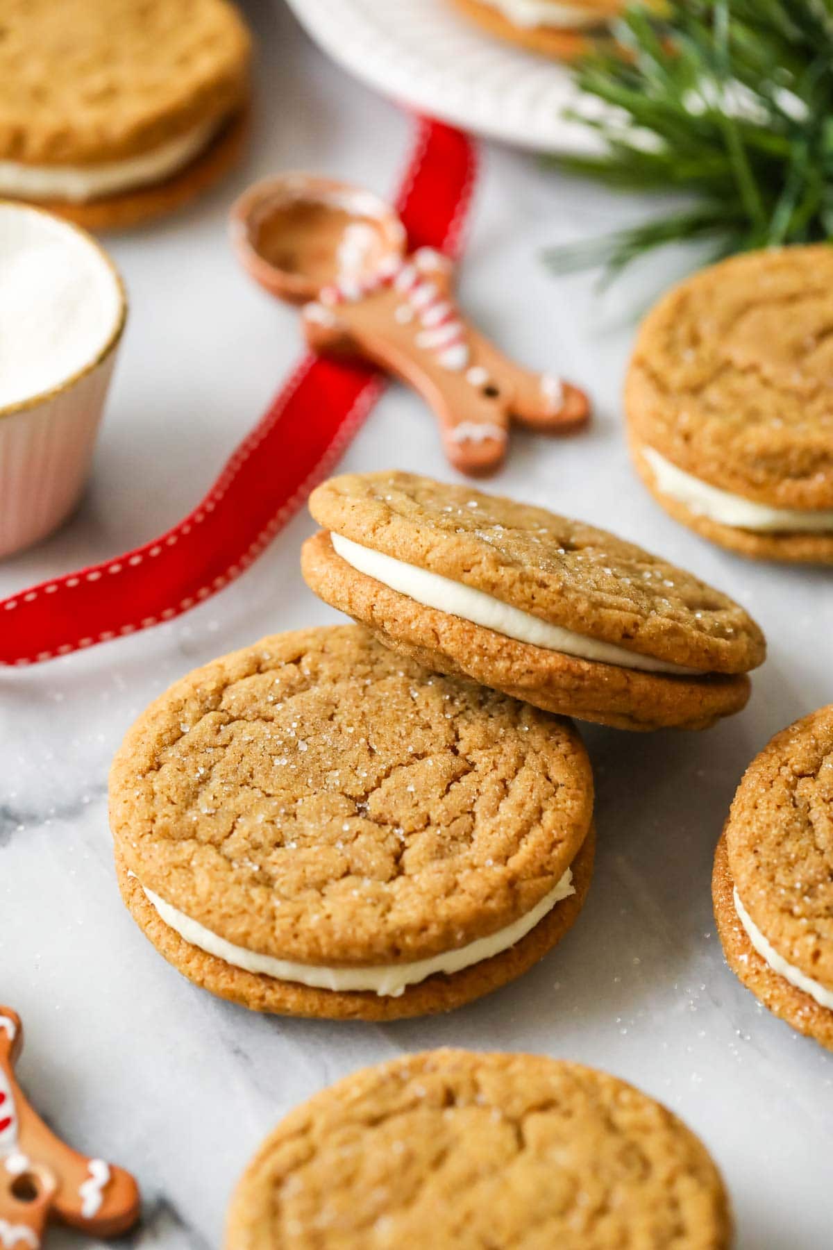 Two sandwich cookies made with gingerbread cookie dough and a white chocolate buttercream.