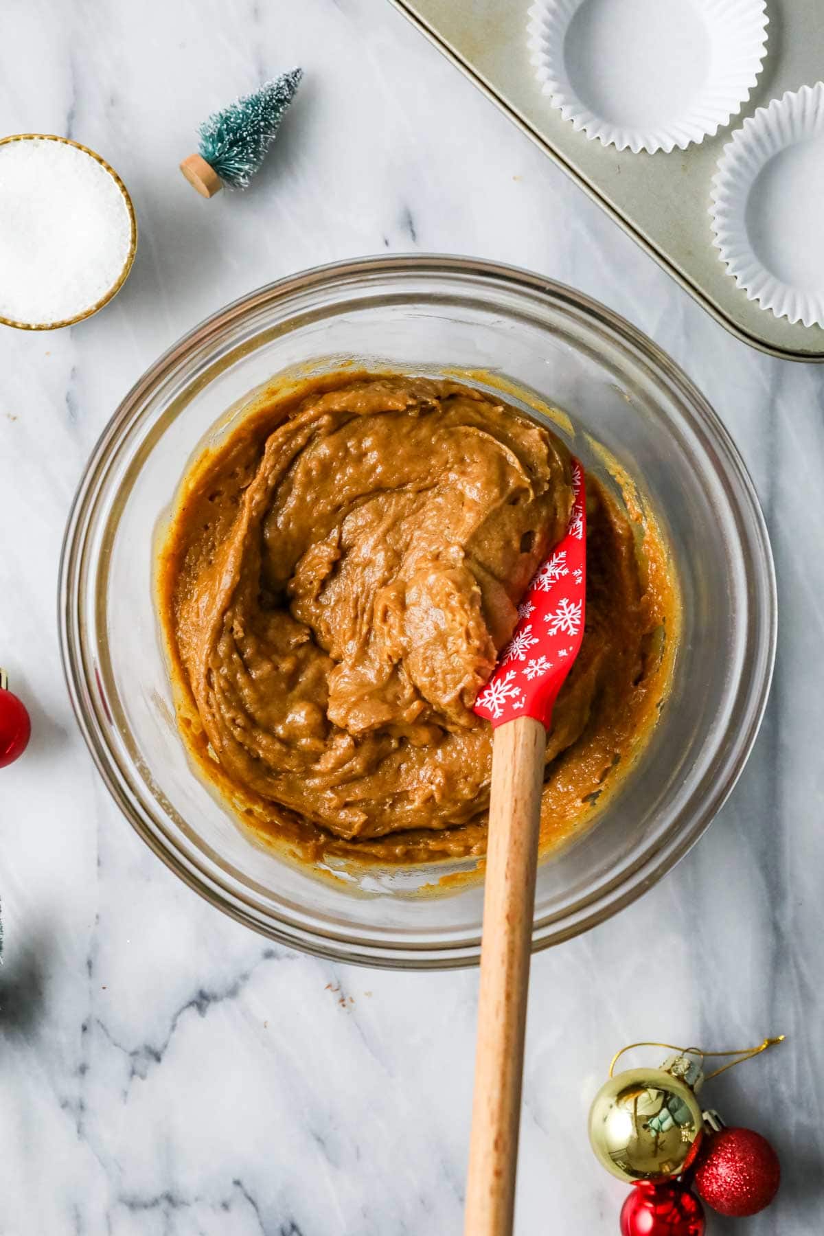 Overhead view of a bowl of gingerbread muffin batter in a bowl.