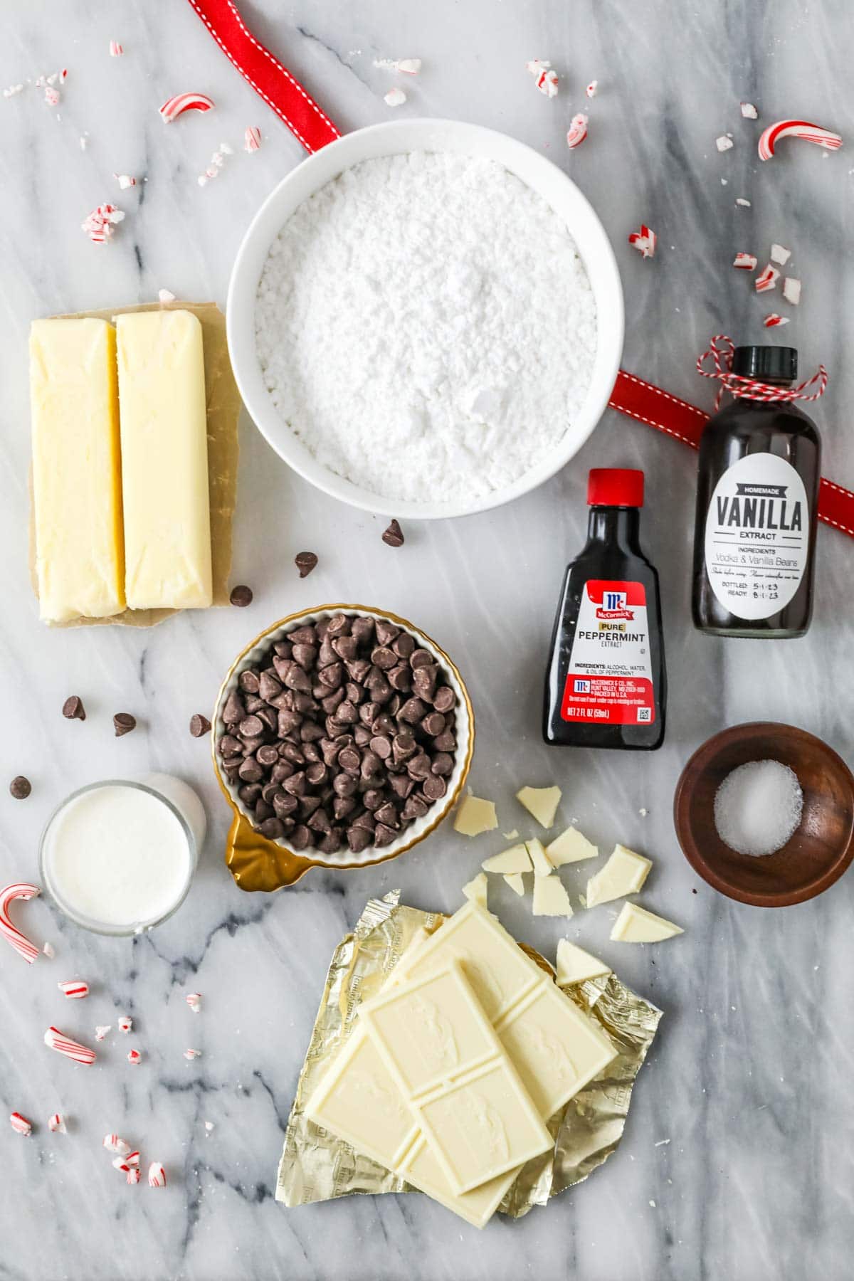 Overhead view of ingredients including white chocolate, peppermint extract, butter, and more.