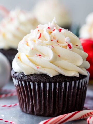 Peppermint bark cupcake topped with crushed peppermint candies.