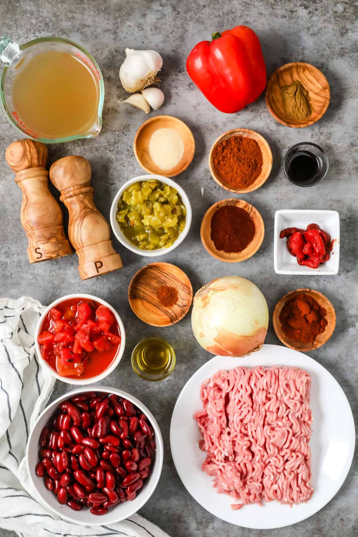 Overhead view of ingredients including spices, ground turkey, veggies, and more.