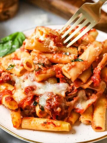 Plate with a serving of baked ziti.