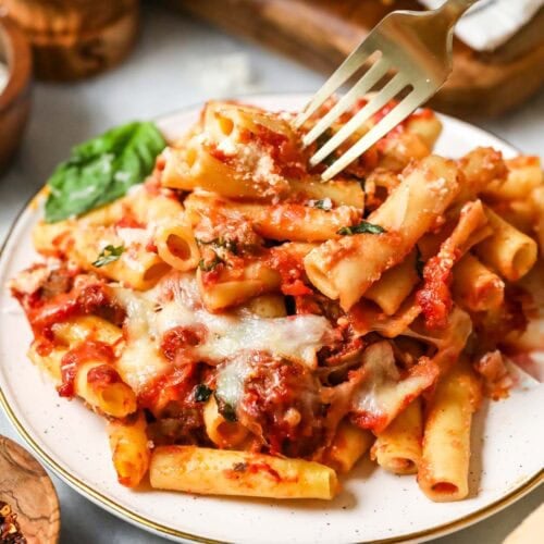 Plate with a serving of baked ziti.