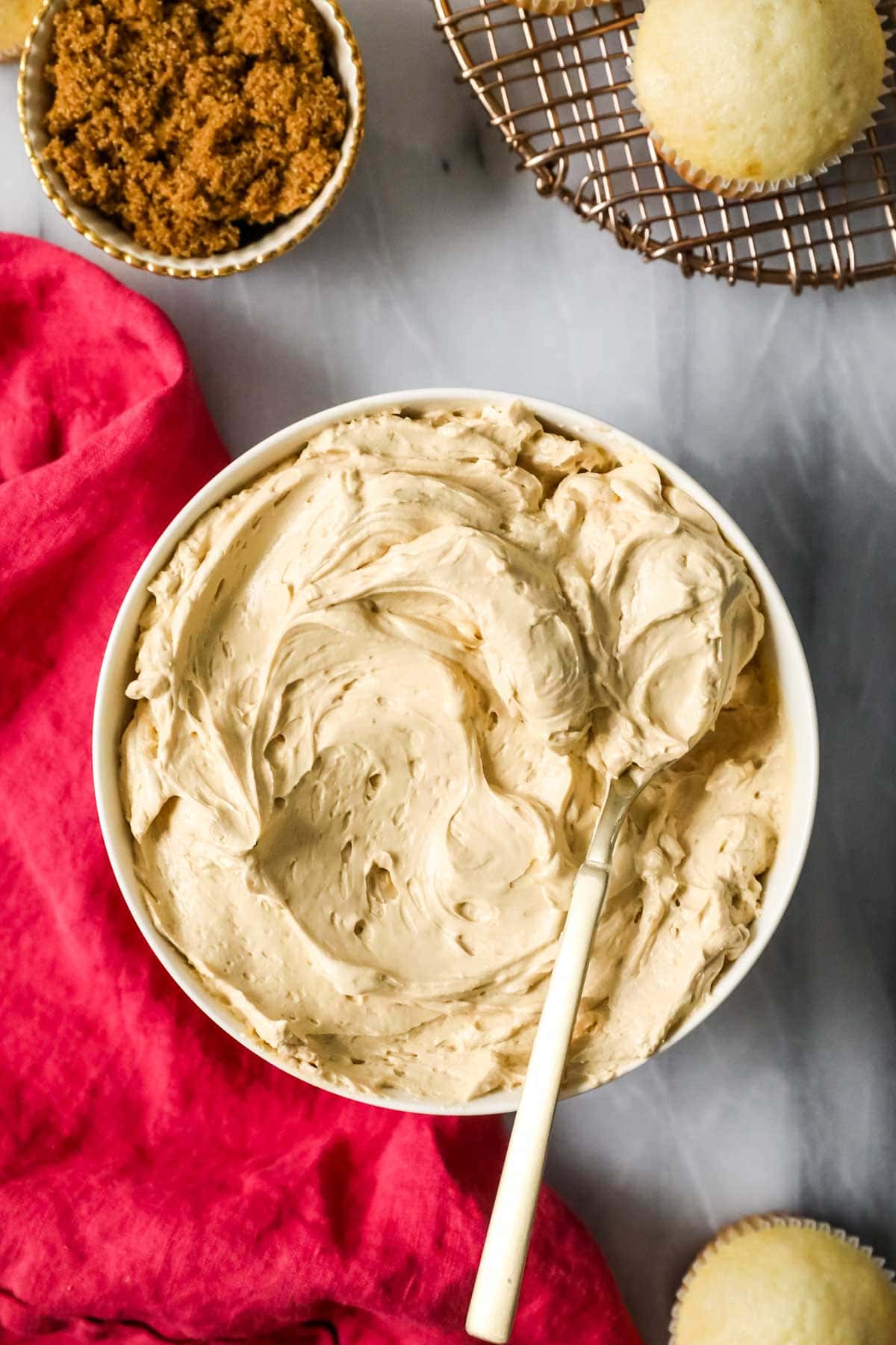 Overhead view of a bowl of swiss meringue buttercream made with brown sugar.