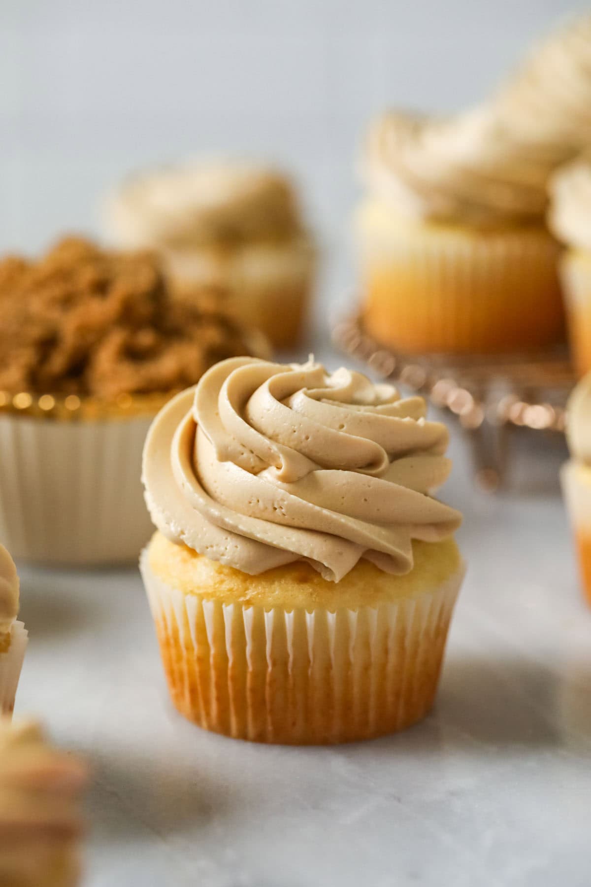 Cupcake topped with a swirl of swiss meringue buttercream made with brown sugar.