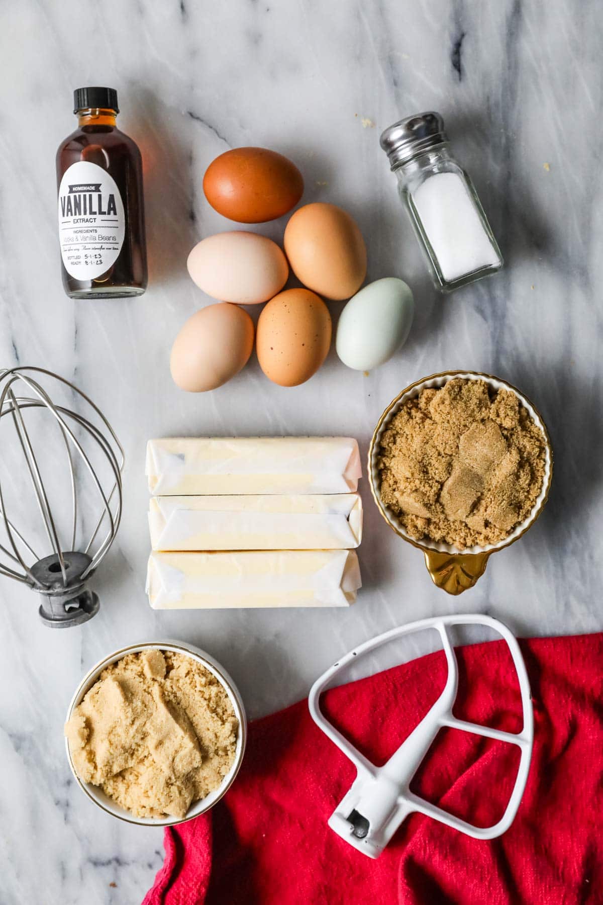 Overhead view of ingredients including brown sugar, butter, vanilla, eggs, and salt.